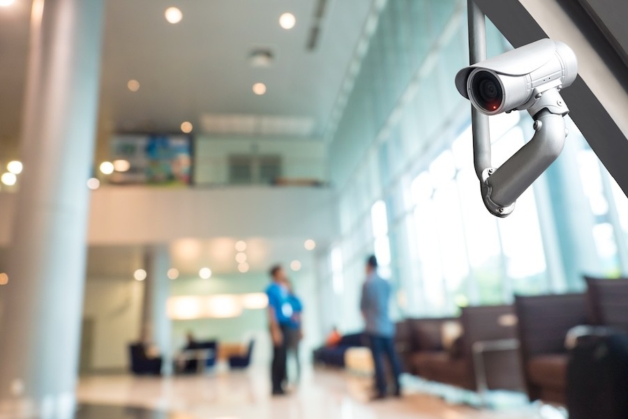 A security camera keeps watch in a business lobby.