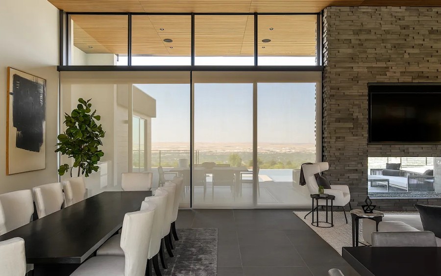 Contemporary residence showcasing elegant motorized shades that perfectly balance light control and views.