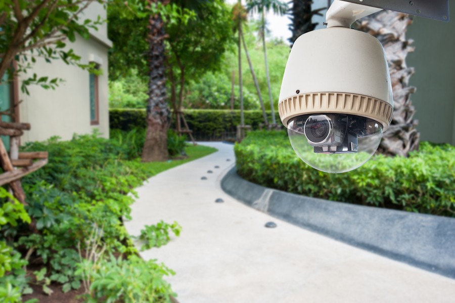 Close-up on a camera outdoors in a home surveillance system. 