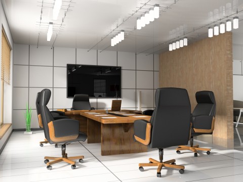 Image is of an office conference room with a TV mounted on the back wall.