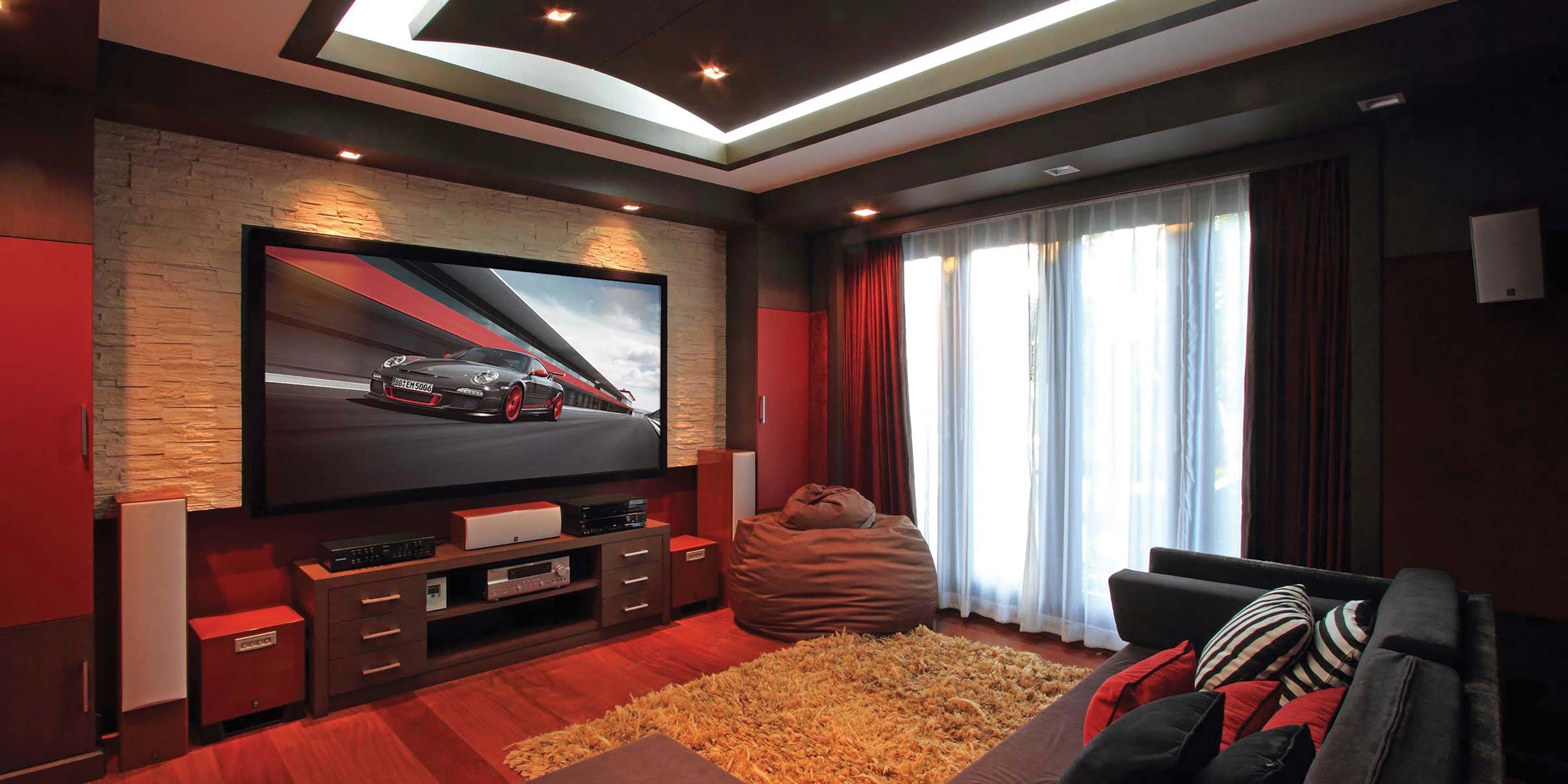 Large screen, red room, media room, car on tv