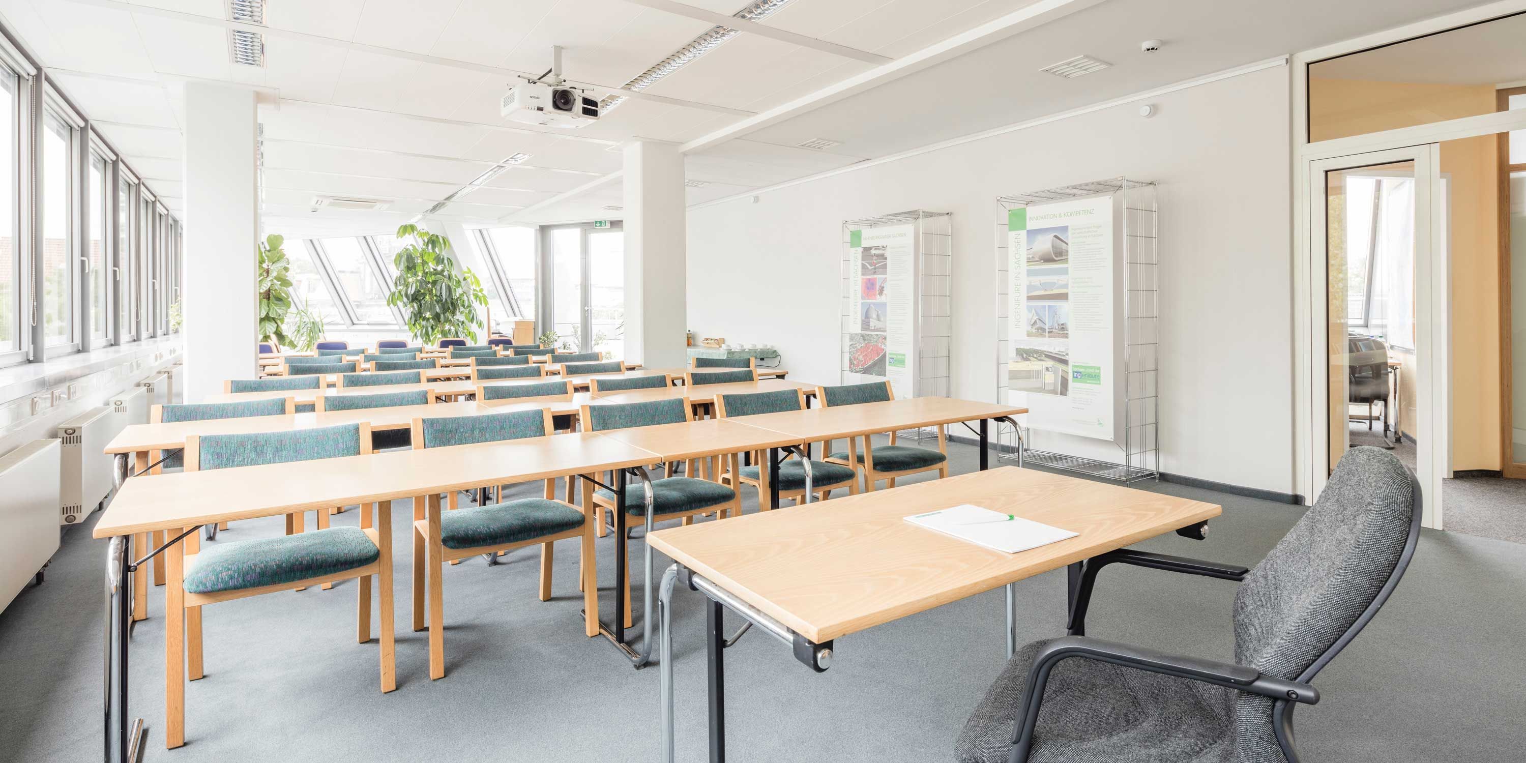 training room, fabric chairs, wooden desks, projector, white